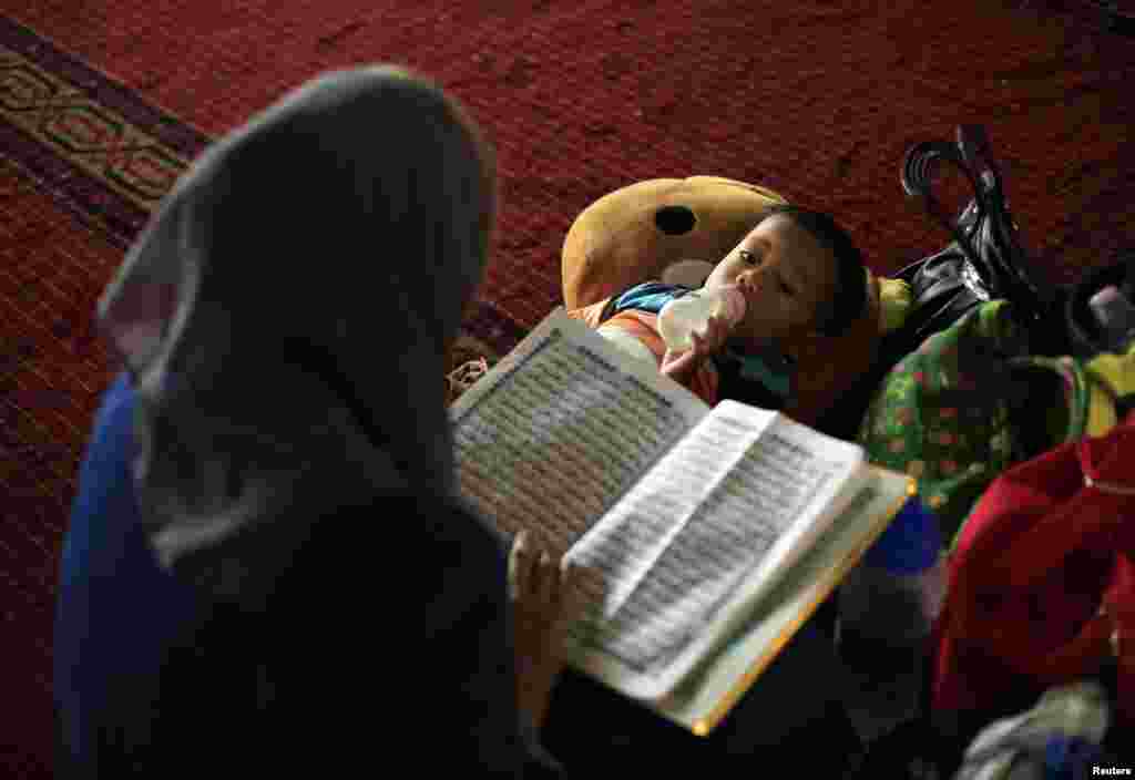A mother and child after mass Friday prayers inside Istiqlal Mosque in Jakarta, July 4, 2014.
