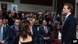 Meta CEO Mark Zuckerberg turns to address the audience during a Senate Judiciary Committee hearing on Capitol Hill in Washington, Jan. 31, 2024, to discuss child safety. X CEO Linda Yaccarino watches at left.