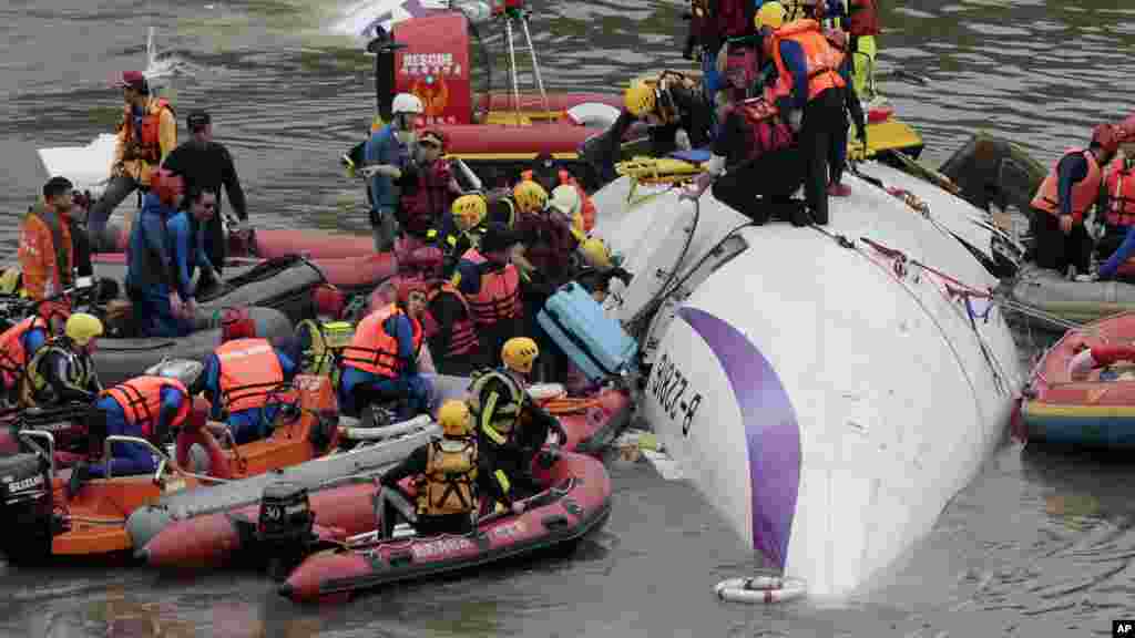Emergency personnel try to extract passengers from a commercial plane after it crashed in Taipei, Taiwan.