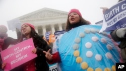 FILE: Protesters demonstrate in front of the Supreme Court, as the court heard arguments in the challenges to a US health care law requiring businesses to provide employees with insurance that includes contraceptives, on Mar. 25, 2015. 