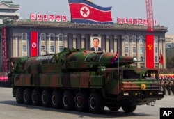 FILE - North Korean vehicle carrying a missile passes by during a mass military parade in Pyongyang's Kim Il Sung Square on April 15, 2012.