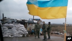 Ukrainian soldiers guard a check point near the town of Debaltseve, Donetsk region, Feb. 3, 2015.