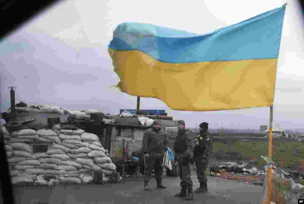 Ukrainian soldiers guard a check point near the town of Debaltseve, Ukraine, Feb. 3, 2015.