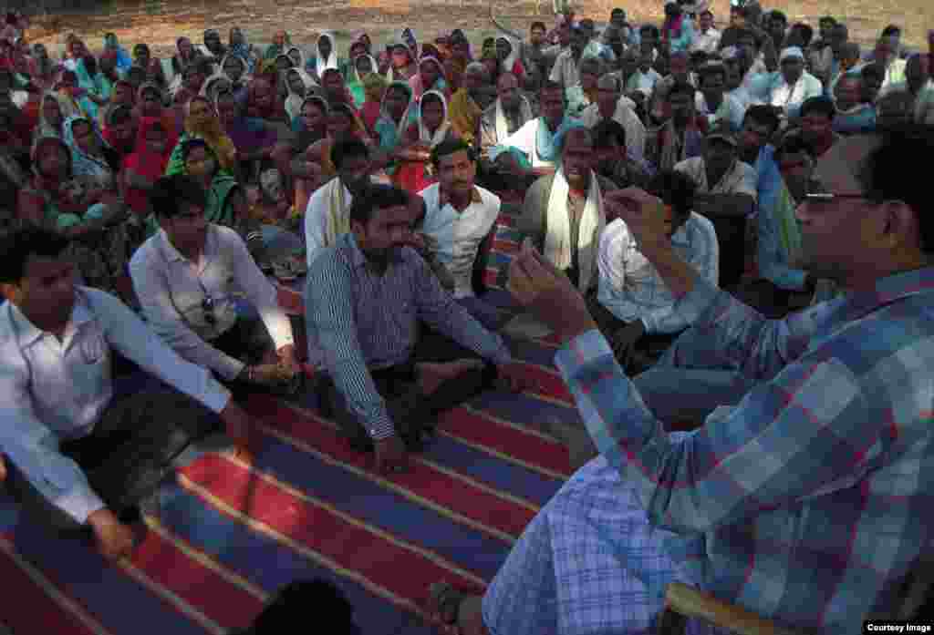 Ramesh Agrawal tells villagers that they have legal rights to block a mining project slated for development on their land. (Goldman Environmental Prize)