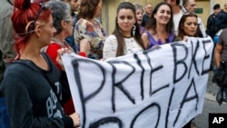 Demonstrators hold up a sheet with writing reading in Italian "Priebke murderer" outside the Society of St. Pius X, a schismatic Catholic group, where Nazi war criminal Erich Priebke funeral was taking place, in Albano Laziale, on the outskirts of Rome, O