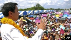 Thai caretaker Prime Minister and leader of Democrat party Abhisit Vejjajiva makes a speech to supporters during an election campaign in Petchabun province, northeastern Thailand Saturday, June 18, 2011
