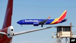 FILE - A Southwest Airlines Boeing 737 Max aircraft lands at the Southern California Logistics Airport in the high desert town of Victorville, Calif., March 23, 2019.