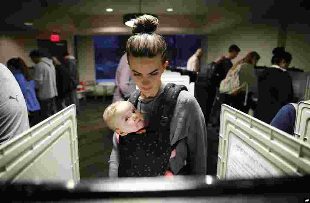 Kristen Leach votes with her six-month-old daughter, Nora, on election day in Atlanta, Nov. 6, 2018.