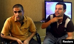 Mohammed Abd Ahmed, right, and Ahmed Mahmoud Mustafa, two of the 69 hostages rescued from an Islamic State prison in a joint raid by U.S. and Kurdish special forces, attend an interview with Reuters in Irbil, Iraq, Oct. 29, 2015.