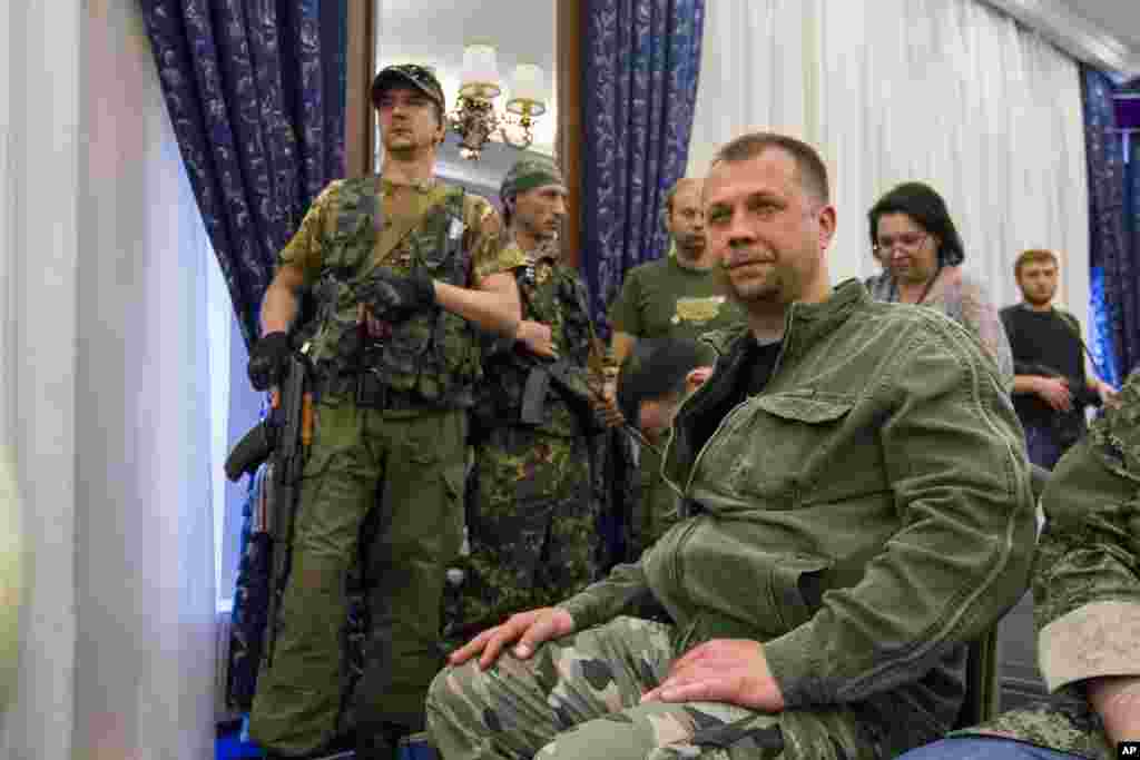 Prime minister of the self-declared Donetsk republic Oleksandr Boroday, sits with armed security during the congress of representatives of Ukrainian south-east regions, in Donetsk, Ukraine, May 24, 2014.