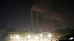 FILE - Steams spew from the chimneys of a coal power plant, in Cilegon, Banten province, Indonesia, on Oct. 3, 2023. Pollution is causing respiratory illnesses and deaths to rise in Indonesia's island of Java, including the capital, Jakarta.