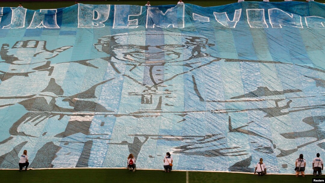 A banner with the Pope's photo is displayed on the field of the Maracana stadium before a soccer game in Rio de Janeiro Jul. 21, 2013.