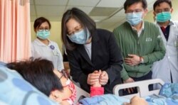 In this photo released by her office, Taiwan President Tsai Ing-wen visits those injured in Friday's train derailment, at a nearby hospital in Hualien, Taiwan, April 3, 2021.