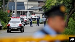 Police zabitləri hücuma məruz qalmış Tsukui Yamayuri-en obyektinin qarşısında keşik çəkirlər. 