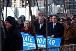 FILE - New York Mayor Bill de Blasio, center top, and other officials and community members march across the Brooklyn Bridge in solidarity with the Jewish community after recent anti-Semitic attacks, Jan. 5, 2020, in New York.