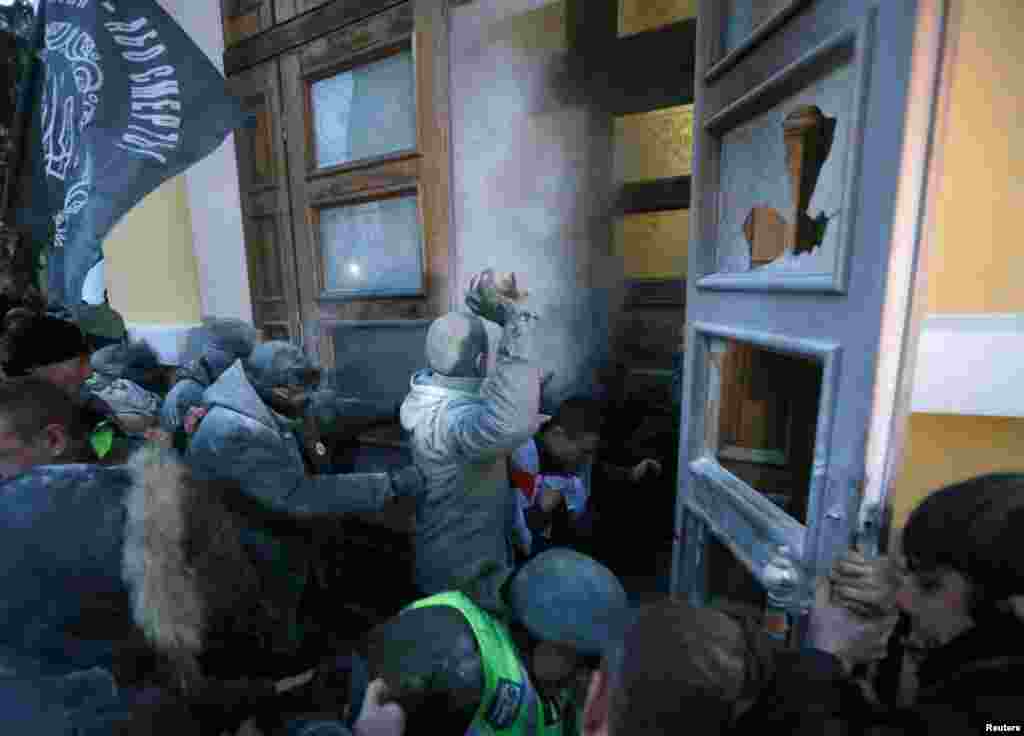 Supporters of former Georgian President and Ukrainian opposition figure Mikheil Saakashvili break into the building of the International Art Center in Kyiv, Ukraine.