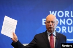 Klaus Schwab, Founder and Executive Chairman of the World Economic Forum holds the meeting's manifesto as he addresses a news conference ahead of the Davos annual meeting in Cologny near Geneva, Jan. 15, 2019.