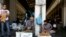 Two street vendors talk each other outside the main fish market of Athens, Aug. 20, 2018, on the day that Greece's eight-year crisis will be officially over. 