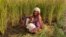 Mamta Kumari, a farm worker, takes a brief break between harvesting wheat on a farm in Nanu village in Uttar Pradesh state, India, on Oct. 17, 2023.