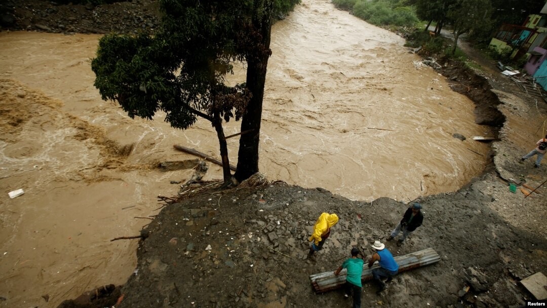 People recover some zinc sheets after a mudslide damaged their homes during heavy rains by Tropical Storm Nate in San Jose, Costa Rica, Oct. 5, 2017.