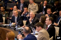 U.S. Secretary for Defense Jim Mattis, center, and NATO Secretary General Jens Stoltenberg, left front, prepare to address a round table meeting of NATO ministers and partners to combat the Islamic State at NATO headquarters in Brussels, Friday, June 8, 2018.