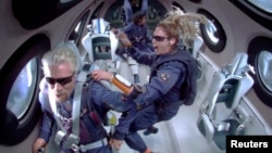 FILE: Billionaire Richard Branson and crew members float in zero gravity on board Virgin Galactic's passenger rocket plane VSS Unity after reaching the edge of space above Truth or Consequences, New Mexico, U.S. July 11, 2021. Virgin Galactic/Handout via REUTERS