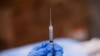 FILE - A syringe is filled with a dose of Pfizer's coronavirus disease (COVID-19) vaccine at a pop-up community vaccination center at the Gateway World Christian Center in Valley Stream, Feb. 23, 2021. 