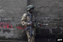 A subordinate   of the M23 rebel radical  picks an unexploded mortar ammunition  from the level  during a cleanup workout  successful  Goma, Democratic Republic of Congo, connected  Feb. 1, 2025.