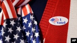 FILE - A voter wears a "I voted" sticker after voting in the Indiana Primary at the Hamilton Co. Auto Auction in Noblesville, Indiana, May 3, 2016.