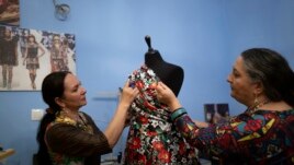 The sisters work together on a design.