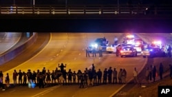 Police confront protesters blocking a highway during demonstrations following the police shooting of Keith Lamont Scott, in Charlotte, North Carolina, Sept. 22, 2016.