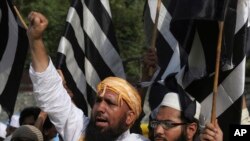 Supporters of Jamiat-e-Ulema Islam, a Pakistani religious group, protest a suicide bombing on May 14, 2017. The Islamic State group says it orchestrated a suicide attack on Abdul Ghafoor Haideri, a Pakistani lawmaker. The attack killed 25 people but only s