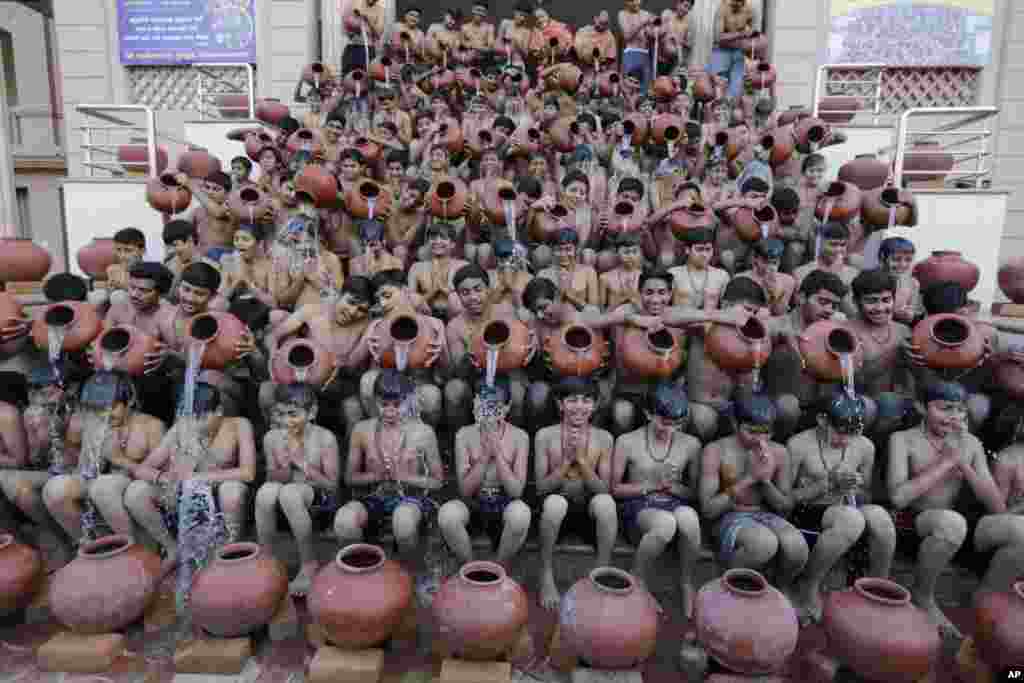 Students of Swaminarayan Gurukul perform a traditional bath called Magh Snan in Ahmadabad, India.