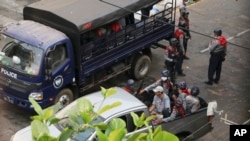 Police leave after arrested several protesters and dismantling their barricades in Yangon, Myanmar, Saturday, March 13, 2021.Security forces in Myanmar on Saturday again met protests against last month's military takeover with lethal force, killing a hand