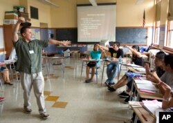 FILE — Teacher Xavier Chavez, standing, teaches a summer history class at Benson High School in Portland, Oregon.
