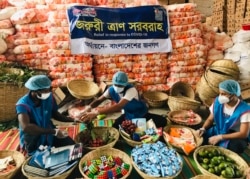 Members of Bidyanondo Foundation pack care packages for COVID-19 patients in Dhaka, Bangladesh, June 6, 2020.