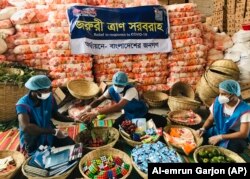Members of Bidyanondo Foundation pack care packages for COVID-19 patients in Dhaka, Bangladesh, June 6, 2020.