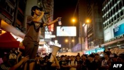 A pro-democracy protester talks on a loudspeaker to there gathered in the Mong Kok district of Hong Kong, Oct. 5, 2014. 