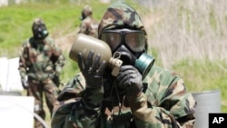 FILE - A U.S. Army soldier drinks water during a CBR (chemical, biological and radiological) warfare training exercise at Yeoncheon near the border with North Korea, in South Korea, May 16, 2013. 