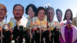 Abortion rights advocates holding cardboard cutouts of the Supreme Court justices demonstrate in front of the U.S. Supreme Court, Dec. 1, 2021, in Washington.