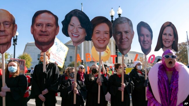 Abortion rights advocates holding cardboard cutouts of the Supreme Court justices demonstrate in front of the U.S. Supreme Court, Dec. 1, 2021, in Washington.