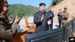 This image made from video of a news bulletin aired by North Korea's KRT July 4, 2017, shows what was said to be North Korea leader Kim Jung Un, center, applauding after the launch of a Hwasong-14 intercontinental ballistic missile, ICBM, in North Korea's northwest. Independent journalists were not given access to cover the event depicted in this photo.