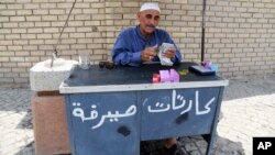 FILE - An Iraqi street currency exchanger counts banknotes in Baghdad, Aug. 8, 2015.