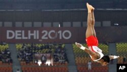 William Albert of Trinidad and Tobago performs in the floor exercise in the gymnastics team final during the Commonwealth Games in New Delhi, India, Monday, Oct. 4, 2010.