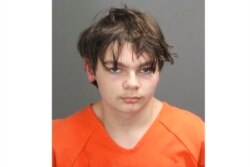 This booking photo released by the Oakland County, Mich., Sheriff's Office shows Ethan Crumbley, 15, who is charged as an adult with murder and terrorism for a school shooting.