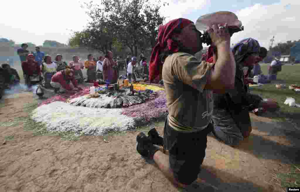 A Maya priest sounds a note on a conch shell horn during the Oxlajuj Batz ceremony to celebrate the end of the Maya calendar in the ceremonial center of Kaminal Juyu in Guatemala City December 12, 2012