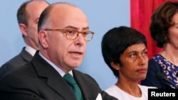 French Prime Minister Bernard Cazeneuve (L), flanked by Ericka Bareigts (R) Minister for France's overseas territories, makes a statement after a meeting on protests in the overseas French department of Guiana, in Paris, France, April 3, 2017.