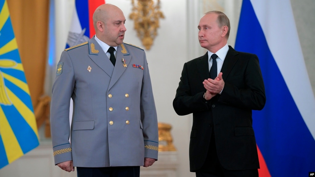 FILE - Russian President Vladimir Putin applauds Col. Gen. Sergei Surovikin during an awards ceremony for troops who fought in Syria, in the Kremlin, in Moscow, Dec. 28, 2017. Putin says Russia's action in Syria has demonstrated the power of the nation's modernized military to the world.