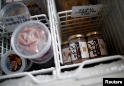 Products of 'Shio-kara', a traditional fermented squid dish, are seen inside a freezer at a factory owned by Takashi Odajima in Hakodate, Hokkaido, Japan, July 19, 2018.