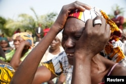 The mother of a missing Chibok girl reacts during a march to the presidential villa in Abuja, Nigeria, calling for their daughters to be brought back home, Jan. 14, 2016.